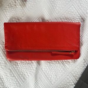 Orange leather clutch